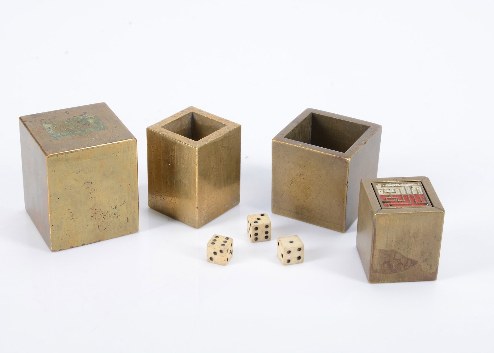 A South East Asia brass Lien Poh (Turning Treasures) game,: A South East Asia brass Lien Poh (Turning Treasures) game, two heavy brass cubes, the smaller fitting inside the larger, the smaller holding a wooden cube and three brass squares with characters ̵