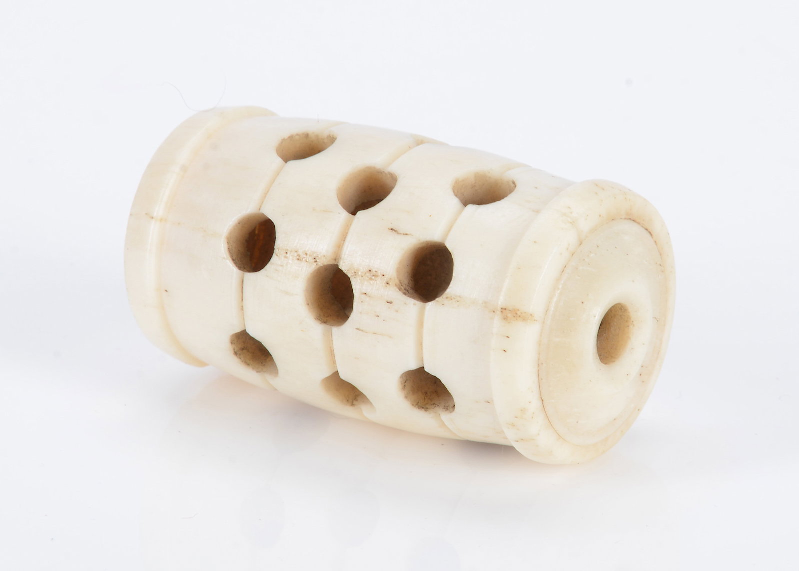 An 19th century bone barrel shaped rattle, (1 of 2)