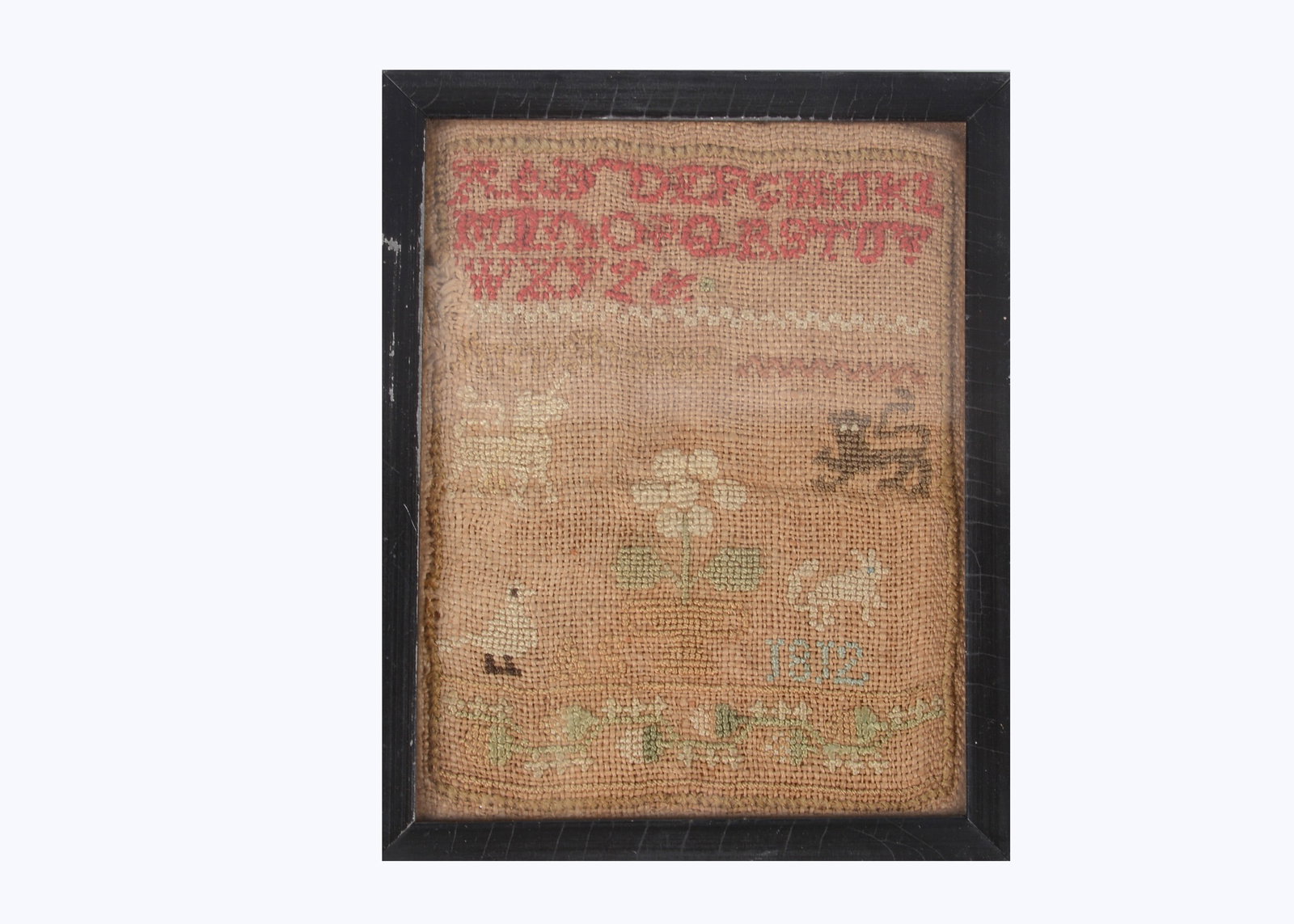 A miniature sampler dated 1812,: A miniature sampler dated 1812, with alphabet in red, a unicorn, lion, bird and white squirrel, initials A.S. and dated 1812, framed —5 1/2in. (14cm.) high (discoloured and faded)
