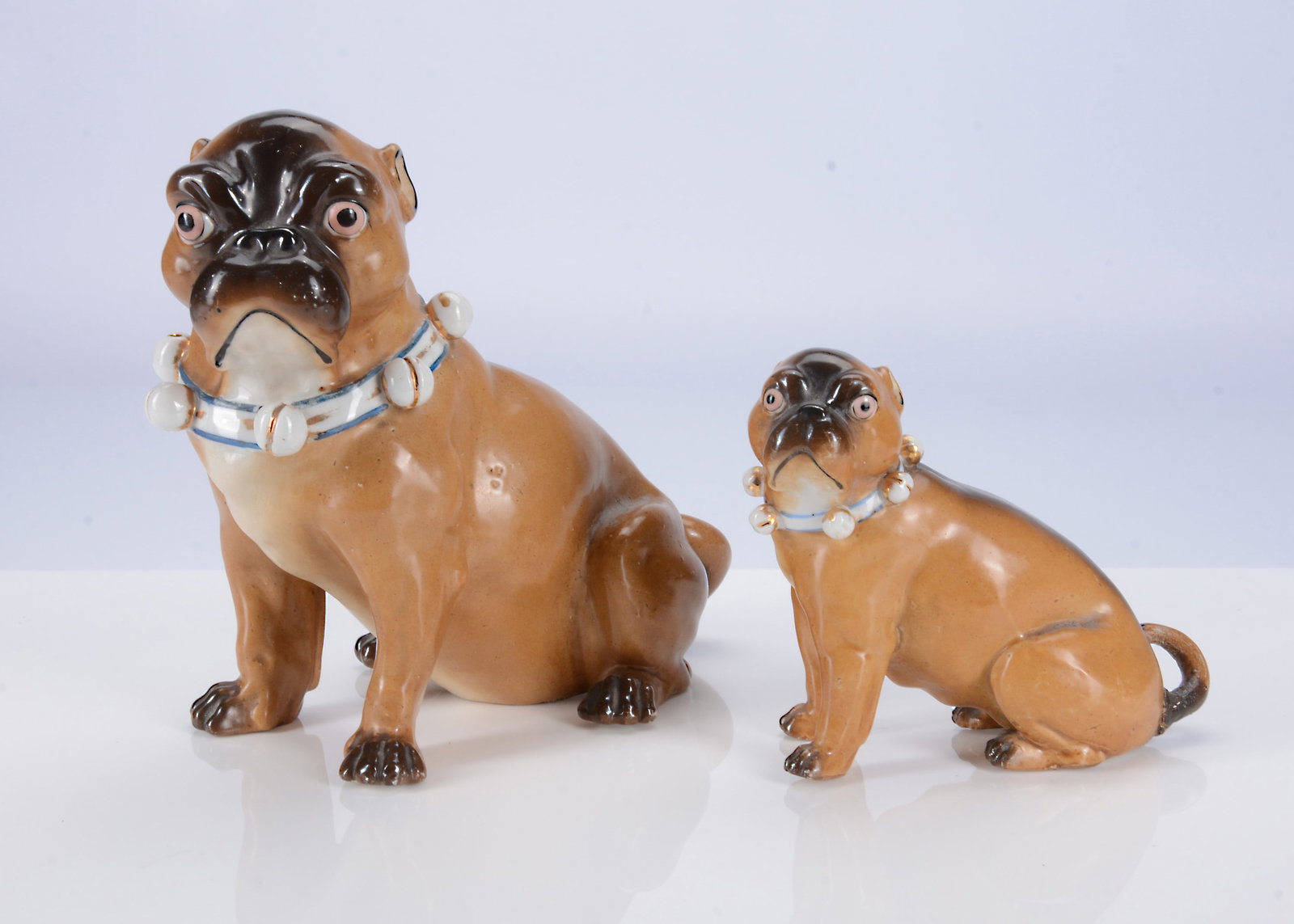 A large and small Conte & Boehme porcelain seat pug dogs, (1 of 1)