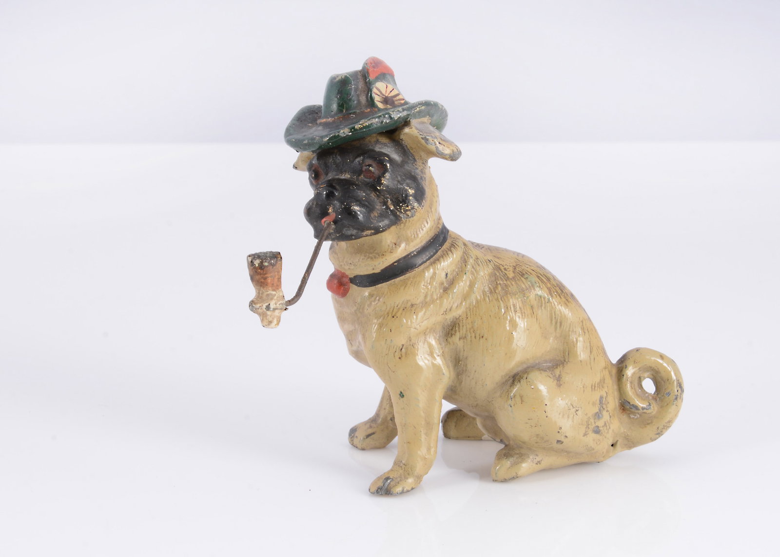 A German lead Heyde-type seated pug smoking a pipe, (1 of 2)