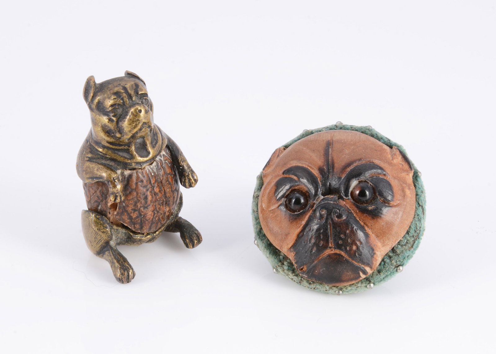 A carved wooden pug dog face pincushion, (1 of 2)