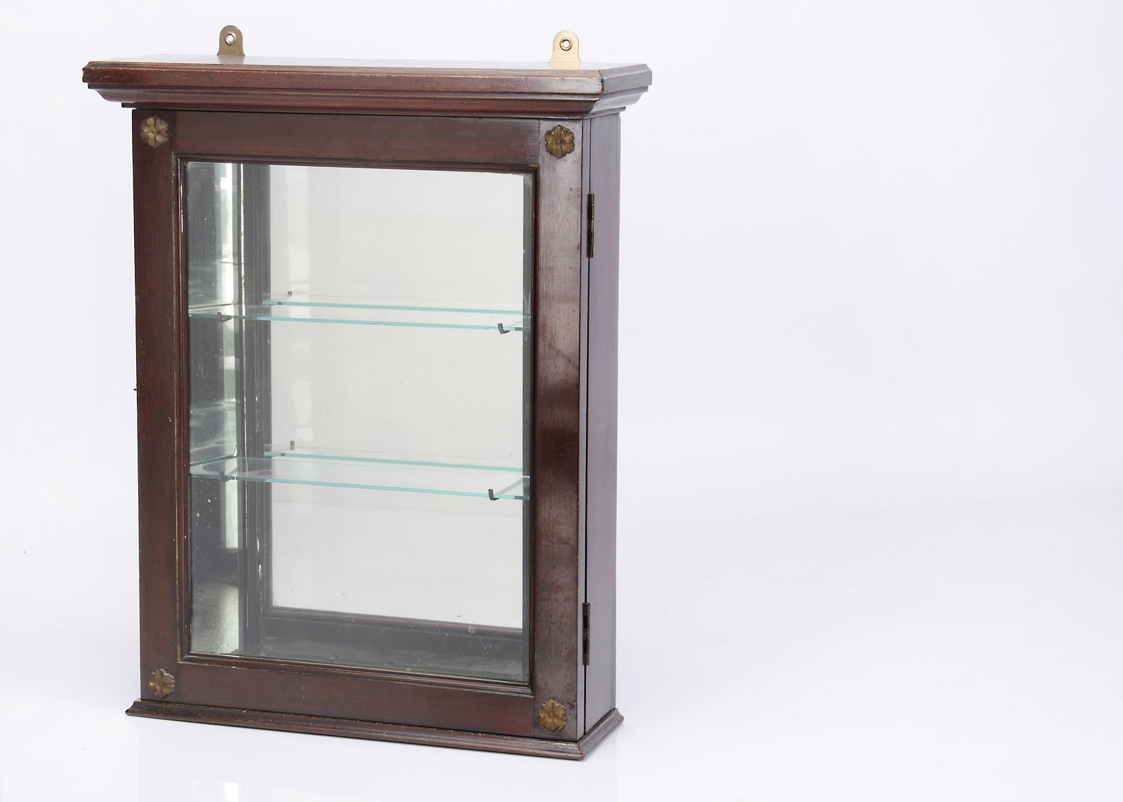 An 19th century small wall mounted display cabinet,: An 19th century small wall mounted display cabinet, mahogany with gilt flower mounts, mirrored back and two glass shelves —18 3/4in. ( 48cm.) high x 13 3/4in. (35cm.) wide