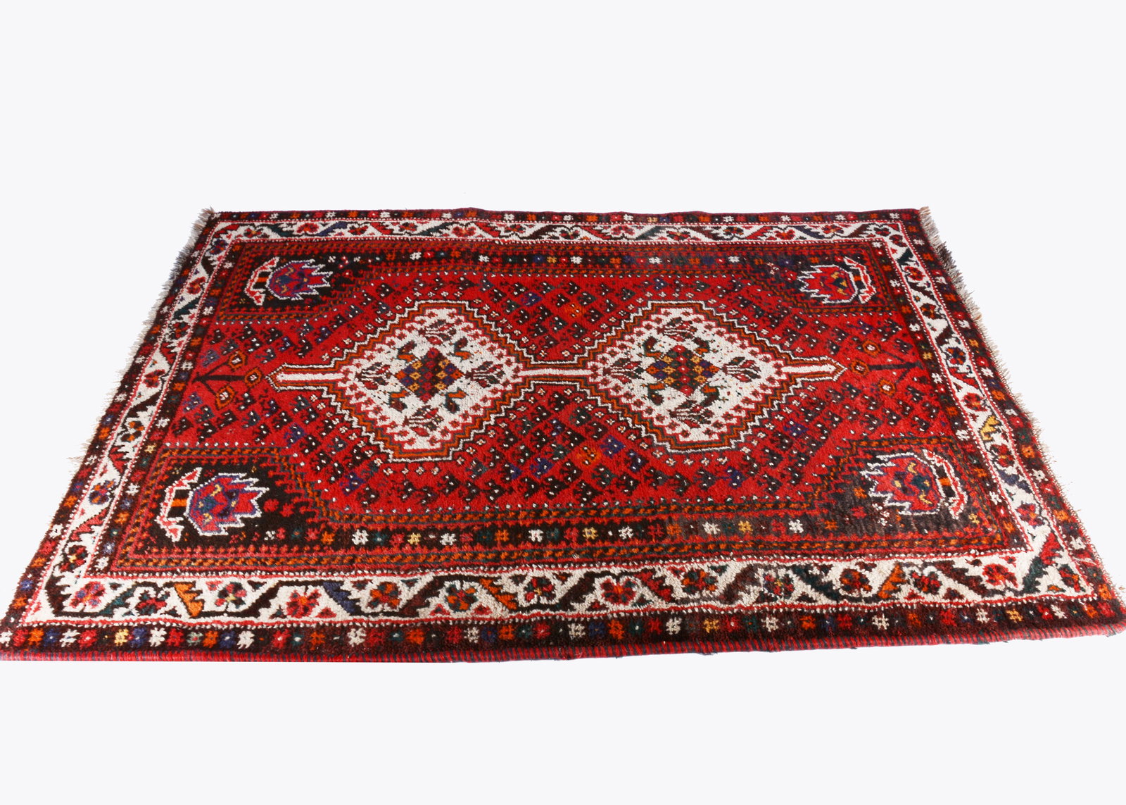 An early 20th century Shiraz woollen hand knotted rug, (1 of 2)