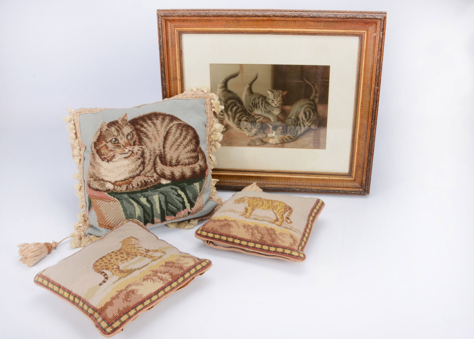 Three cushions and a print of kittens,: Three cushions and a print of kittens, a recent wool work cushion of a fat tabby cat —15in. (38cm.) square; a late 19th century print of three kittens with mouse, framed; and a two small recent 