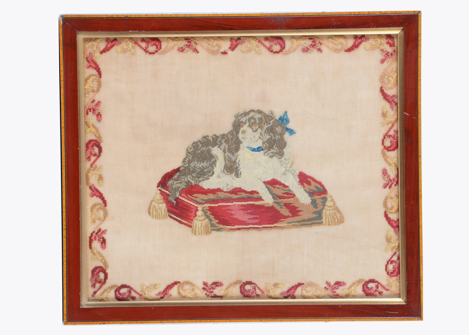 An 19th century wool work of a King Charles spaniel on a cushion, (1 of 1)