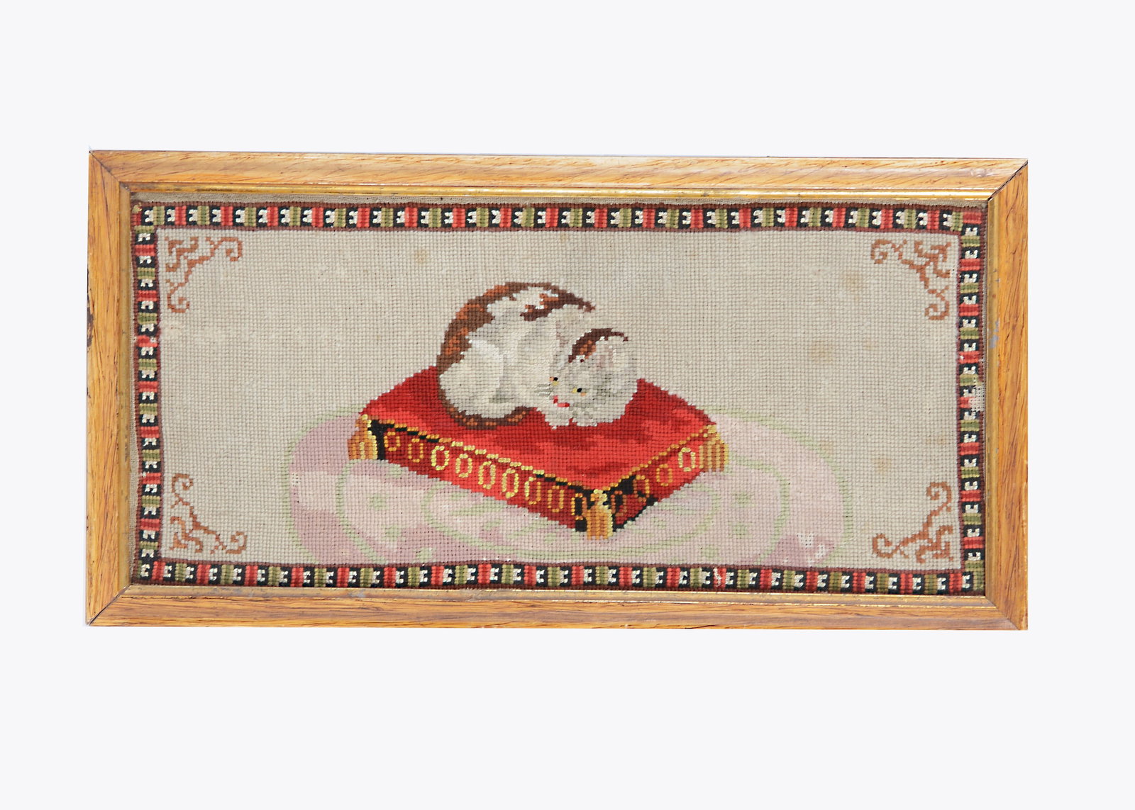 An 19th century wool work of a tortoiseshell cat asleep on a cushion, (1 of 1)