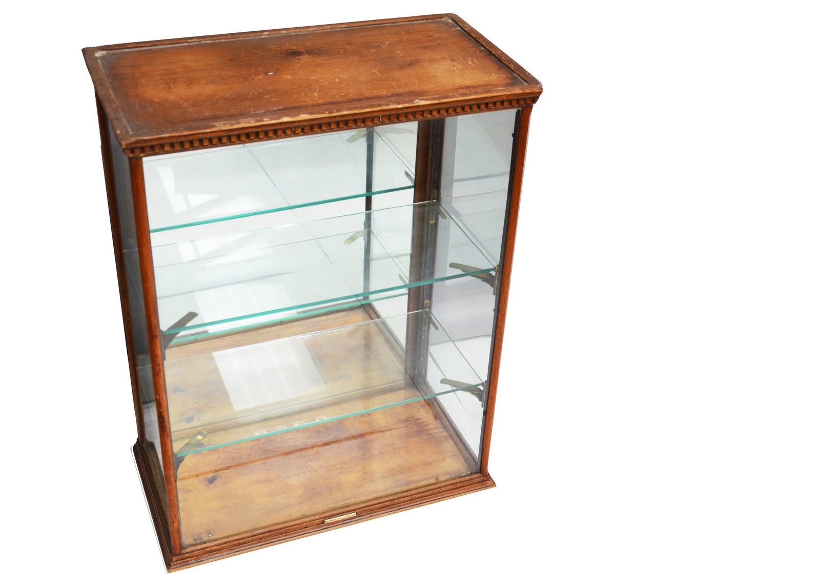 An early 20th century shop counter top display cabinet,: An early 20th century shop counter top display cabinet, made by E. English of Manchester, wooden framed with three sides glazed, two glass shelves and back opening mirrored door —30in. (76cm.) h