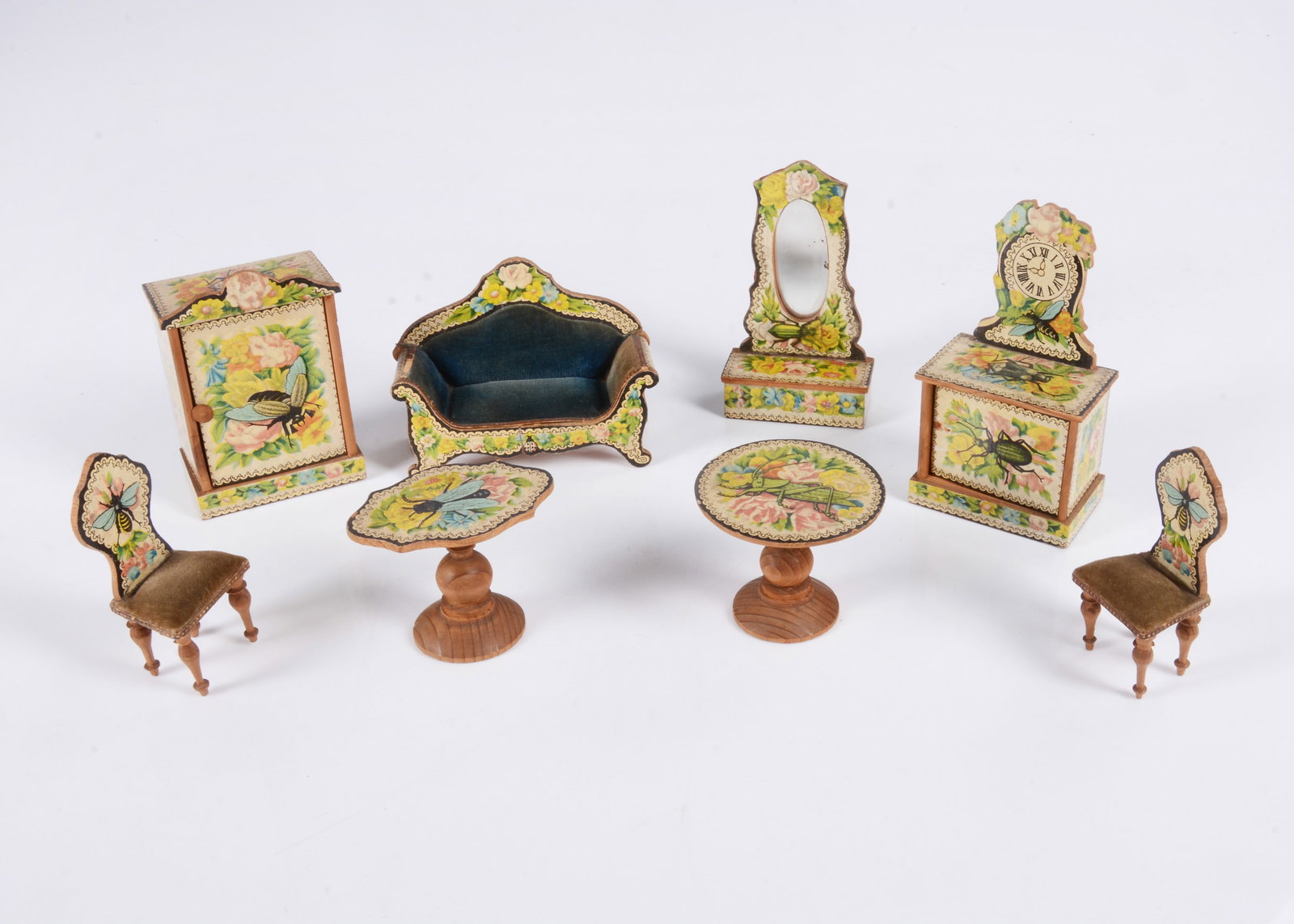 A rare late 19th century German ‘insect’ chromolithographic paper covered wooden: A rare late 19th century German ‘insect’ chromolithographic paper covered wooden dolls’ house drawing room set, comprising sofa with blue velvet upholstery —4in. (10cm.) wide, 