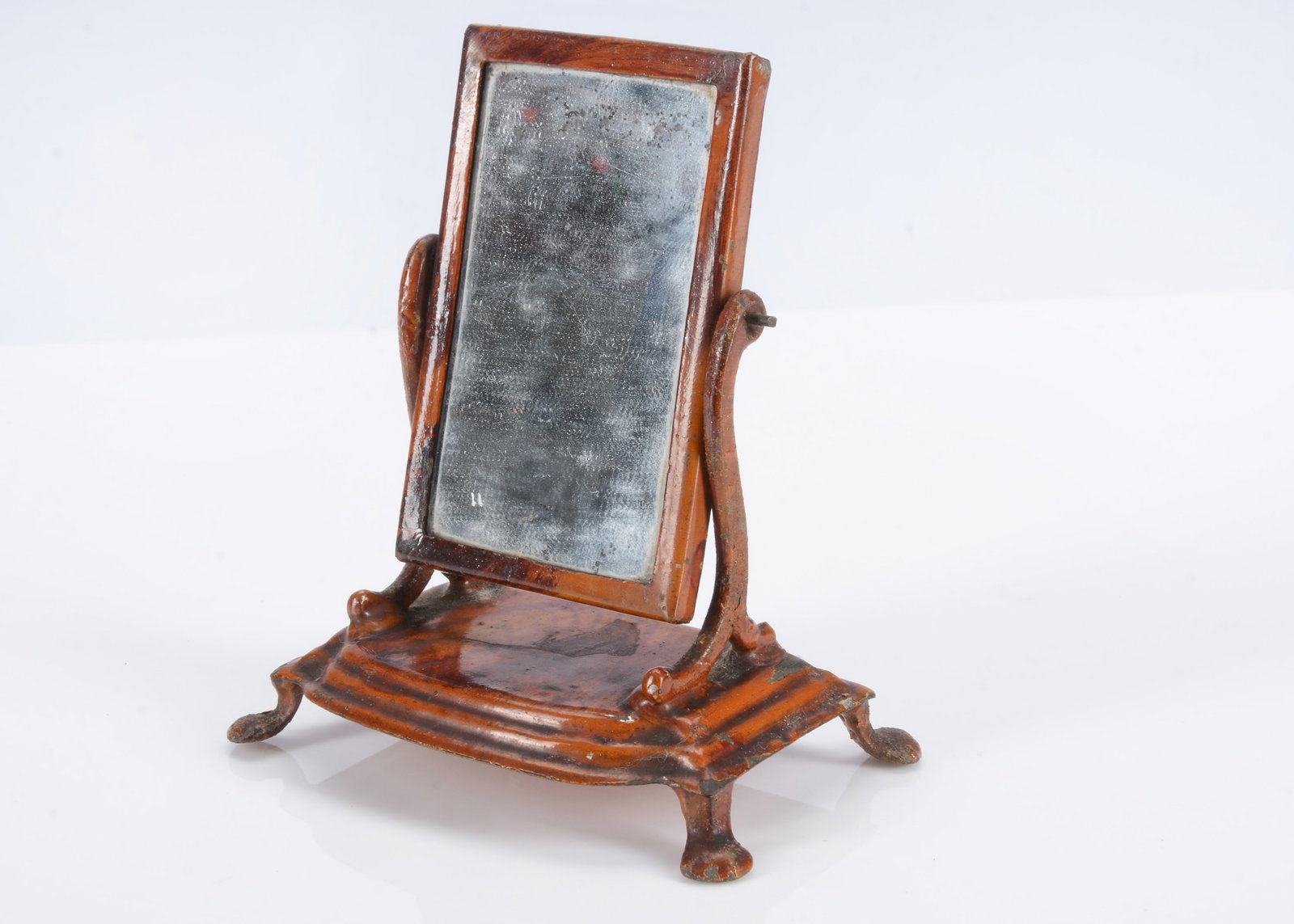 An 19th century Evans and Cartwright painted tinplate dolls’ house toilet mirror, (1 of 2)