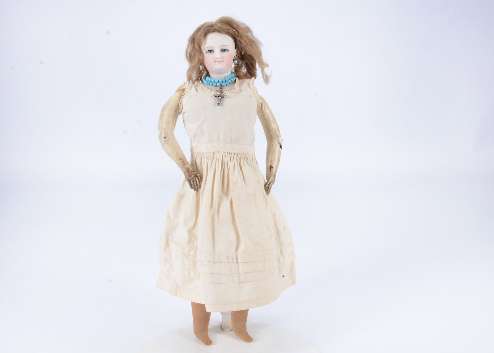 An 19th century smiling Bru swivel head fashion doll,: An 19th century smiling Bru swivel head fashion doll, with unusual fixed glass eyes with two-tone irises, a brown centre surround by a striated blue outer ring, finely painted brows and lashes, closed