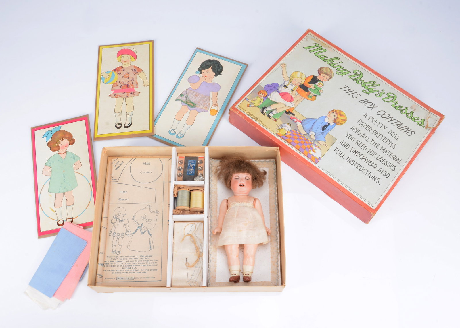 A Spear’s ‘Making Dolly’s Dresses’ with Ernst Heubach bisque headed toddler, (1 of 3)