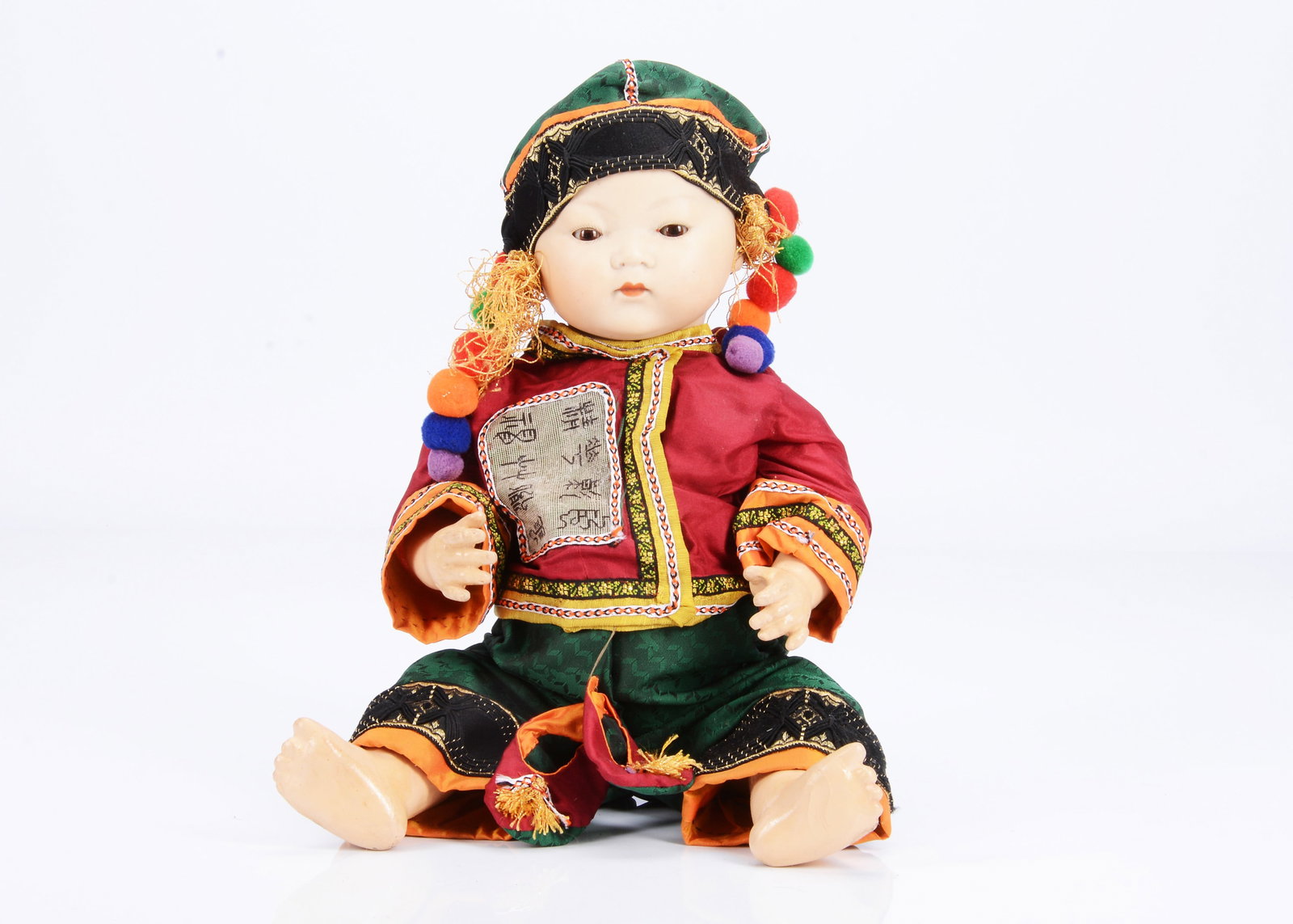 An Armand Marseille 353 Asian baby,: An Armand Marseille 353 Asian baby, with brown sleeping eyes, closed mouth, black spray painted hair, bent-limbed composition pink body and recent outfit —16in. (40cm.) high