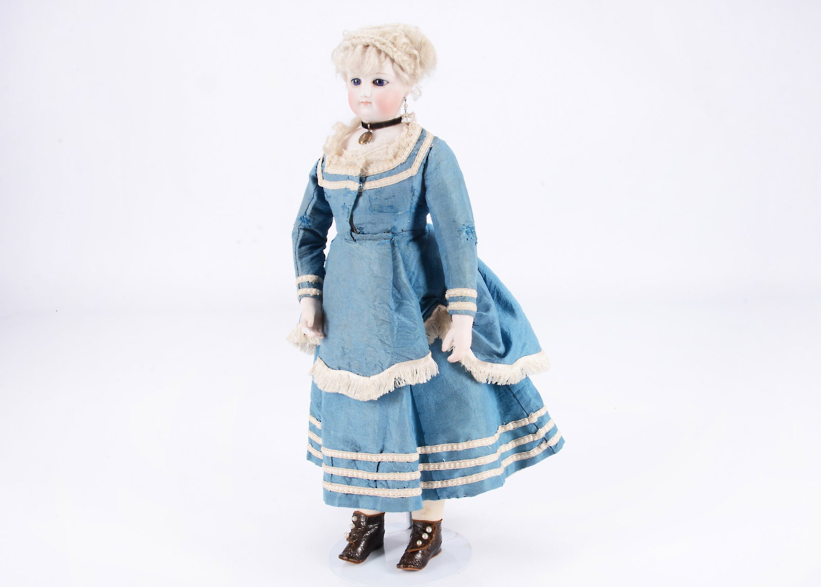 A fine French fashion doll with swivel head,: A fine French fashion doll with swivel head, with fixed deep blue striated glass eyes, light brown painted eyes, red dot to inside corner of eye, close mouth, full face, ears pierced into head, origin