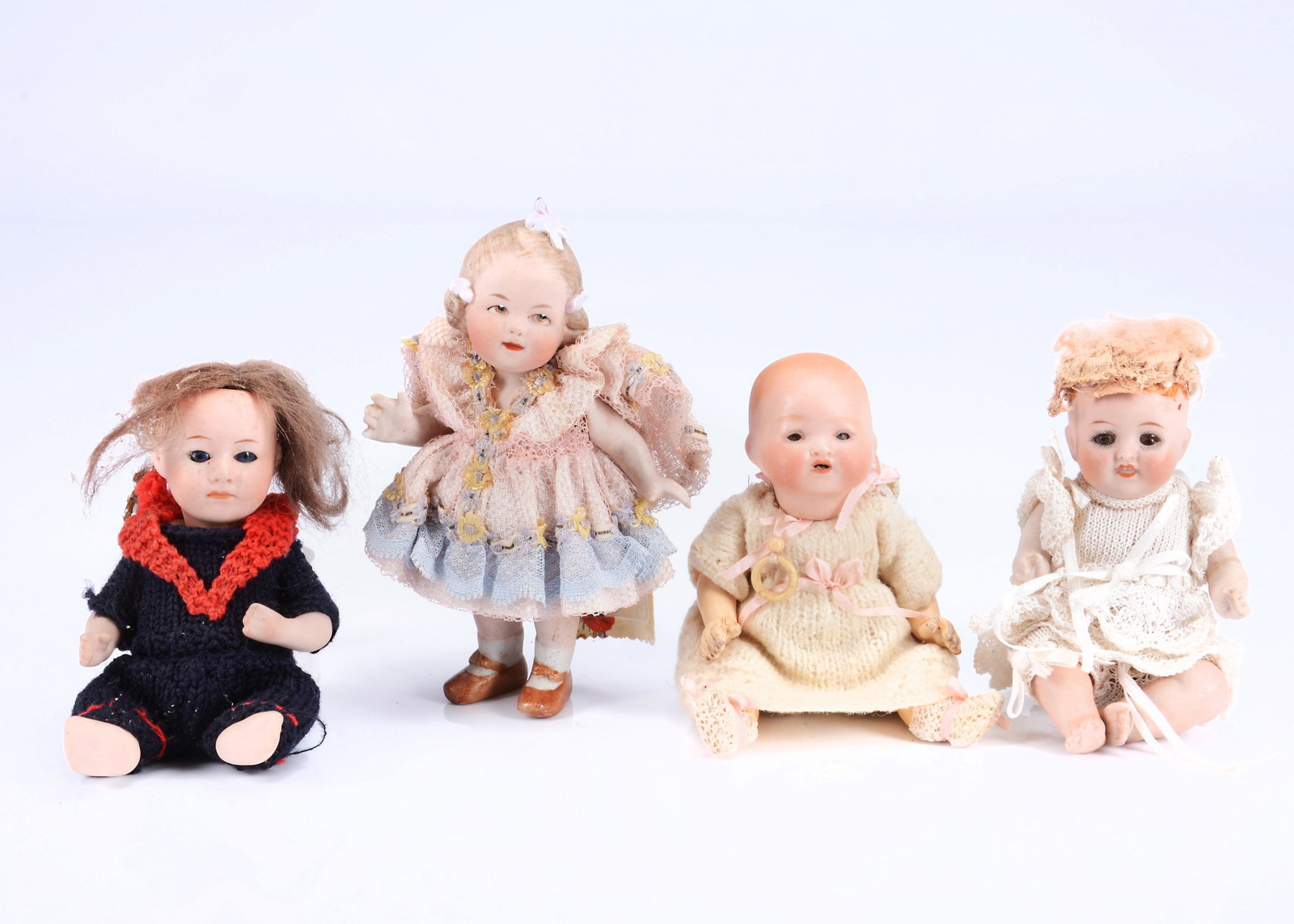Four small character baby dolls,: Four small character baby dolls, an all bisque with impressed 833 to back of fixed neck, with blonde mohair wig, brown sleeping eyes, bent limb body and white crocheted outfit --5 1/2in. (14cm.) high 