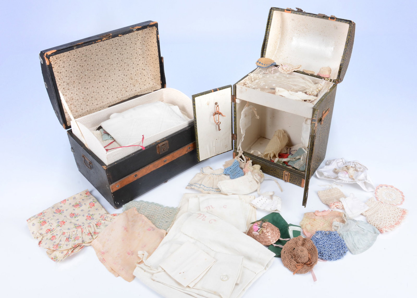 Two 19th century small domed doll's trunks with contents, (1 of 2)