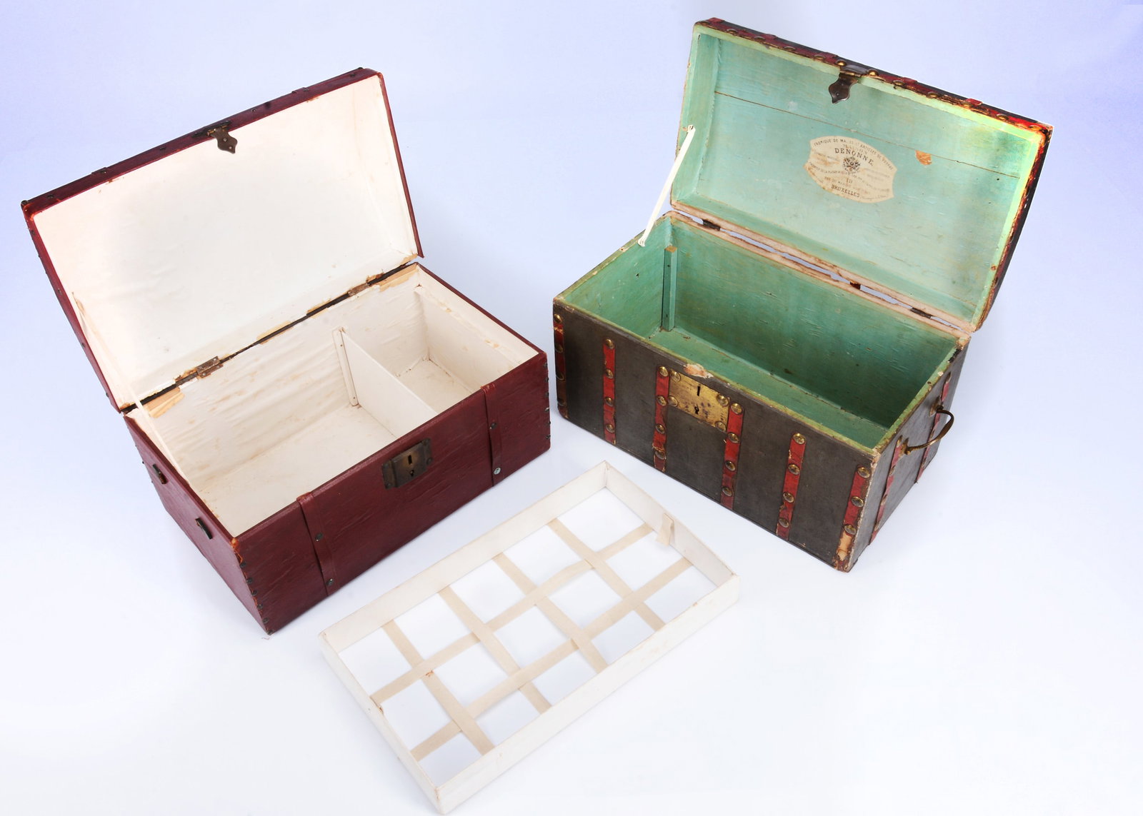 Two 19th century domed doll's trunks,: Two 19th century domed doll's trunks, a green papered trunk, red leather banding with brass studs and brass handles and lock, opening to reveal turquoise papered interior with label, 'Fabrique De Mall