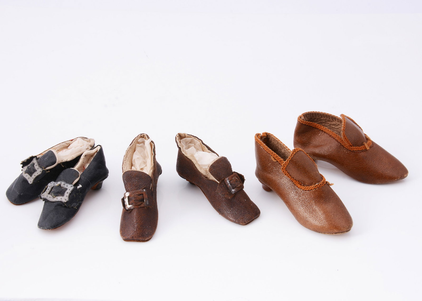 Three pairs of late 19th century heeled doll's shoes, (1 of 2)