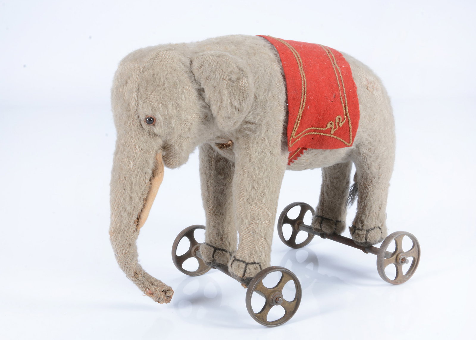 An early Steiff burlap elephant on wheels, circa 1908, (1 of 2)