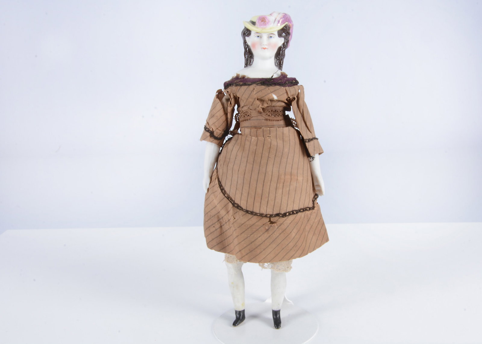 A rare German bisque shoulder-head doll with moulded hat, (1 of 3)