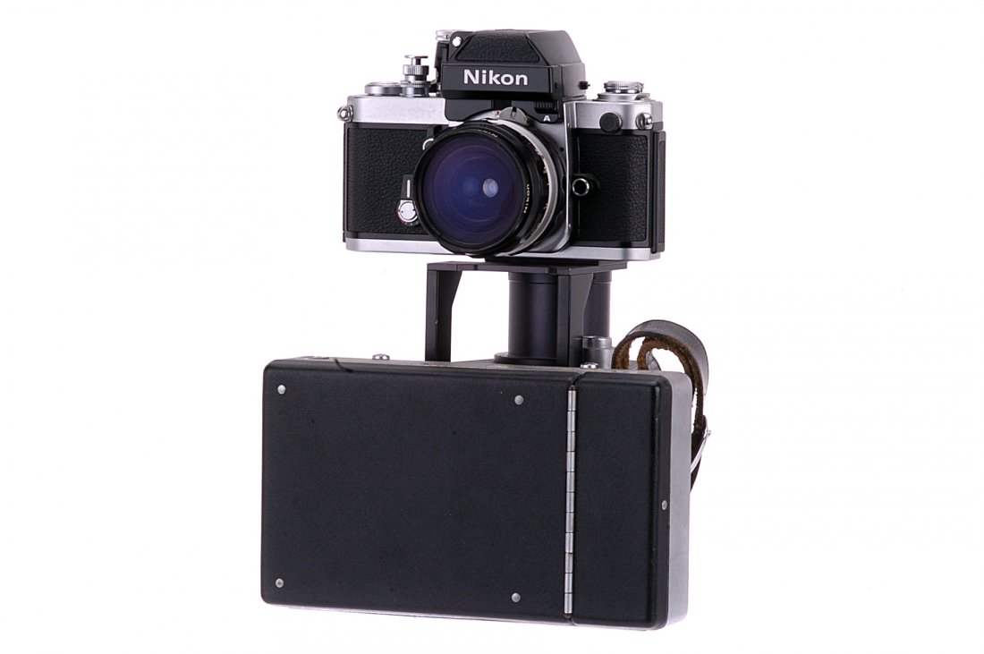 A Nikon F2A Speed Magny 100-2 Camera,: chrome, serial no. 7877106, with Nikkor-H f/3.5 28mm lens, serial no. 682995, body, VG, shutter working, lens, G, with Speed Magny 100-2 Polaroid attachment, by Mikamki & Co. Japan