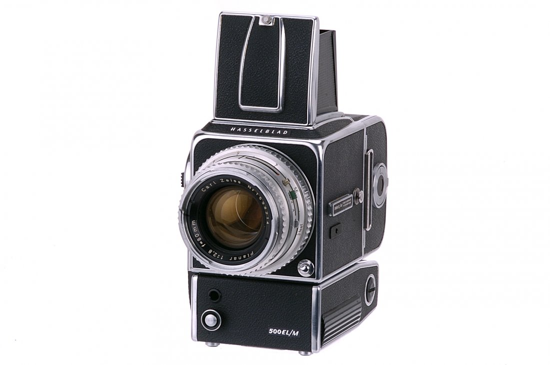 A Hasselblad 500 EL/M Camera,: chrome, serial no. UIE 26115, with Carl Zeiss Planar f/2.8 80mm lens, body, VG, shutter untested, lens, VG, with charger and spare focusing screen