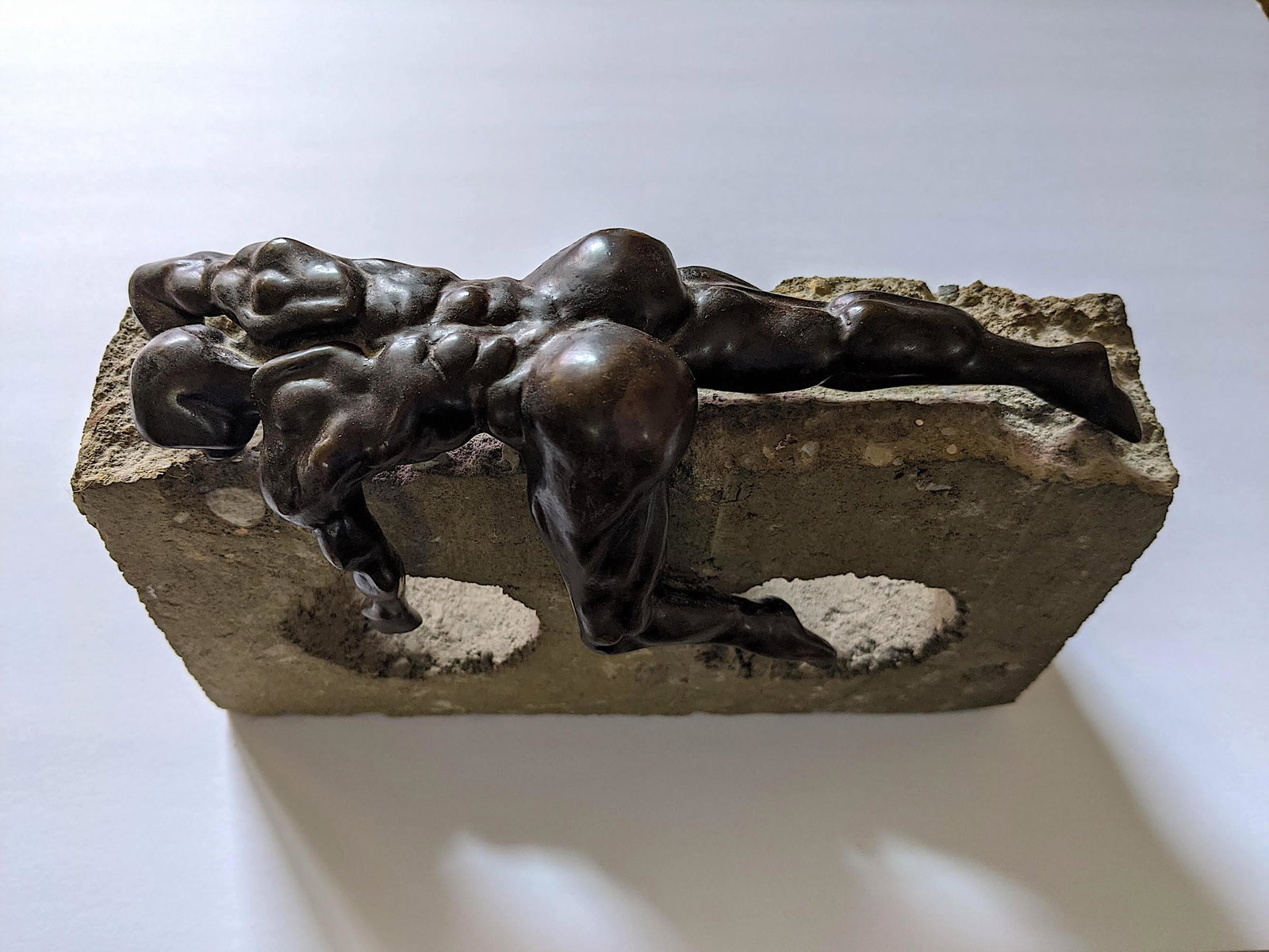 ROBERTO GUTIERREZ LONDONO Bronze Male Nude: Very well done bronze with a male nude laid on a construction block. This artwork is signed and named "El Sueno del Ruso". Limited edition XII/30. The dimensions are Approx. 6.5"H x 9.5" L x 3" D. The