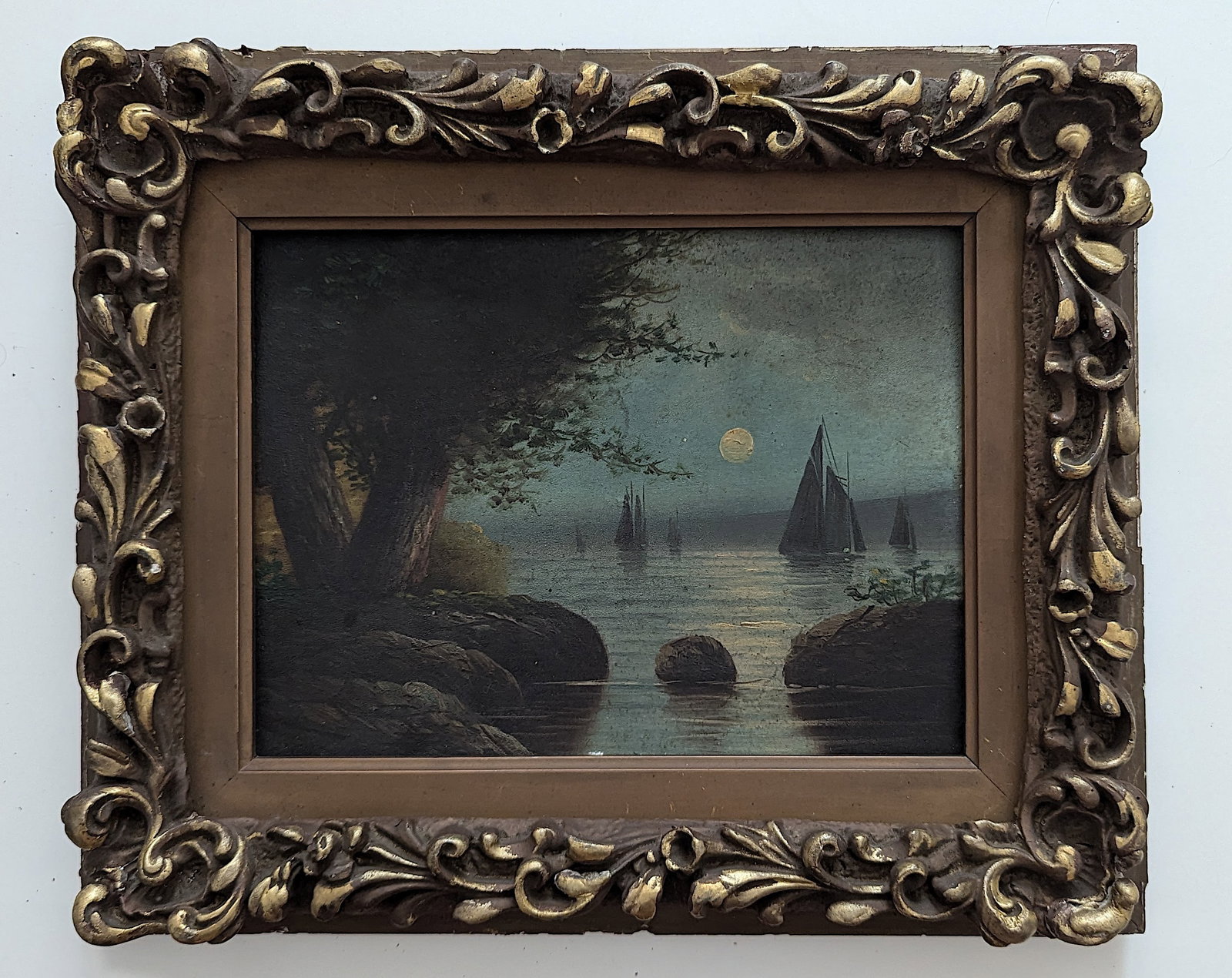 American Oil 19th. Century Moonlit Sail EDWARD MORAN (Manner): Oil on panel scene shows sailboat at night under a full moon on water next to land with two large trees and rocks. Sails are seen in distance. Probably unsigned. The dimensions are Approx. 9" x 11" (B