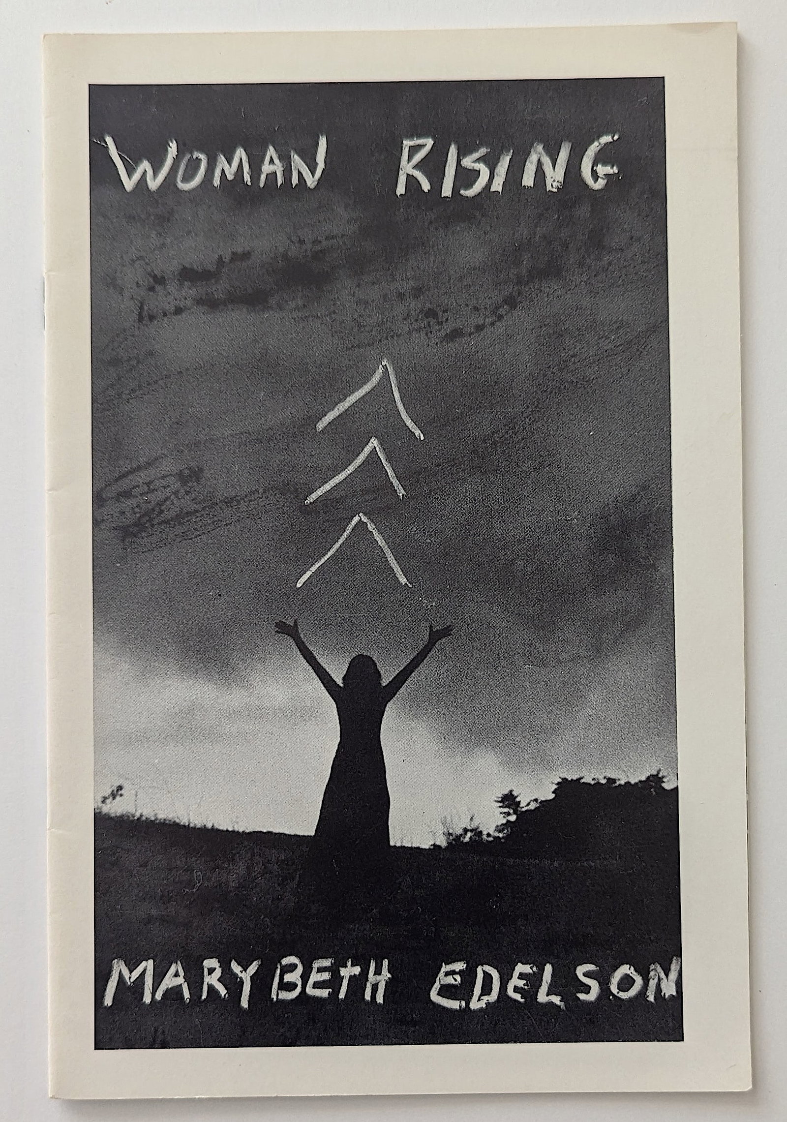 Woman Rising by Edelson, Mary Beth, 1975: Woman rising by Edelson, Mary Beth. Self-published by the author, 1975. Pamphlet. 23p., 5.5x8.5 inch staplebound wraps with a stapled 8.5x11 inch art review on inside back cover written by Susan Solli