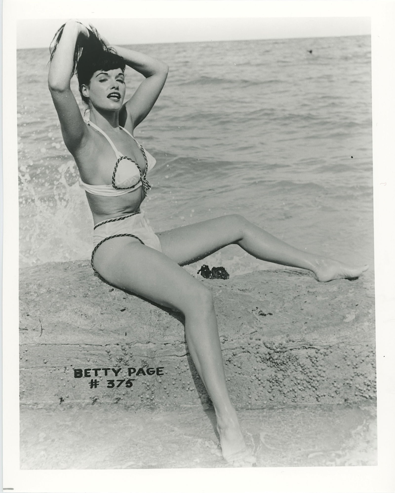 Vintage Photograph Pin-Up Model BETTIE PAGE by Irving Klaw: This lot is coming from the estate of a collector in RI. We have included a quality scan to show it's actual condition. The dimensions are Approx. 10" x 8". This lot is located in Boca Raton, Fl and i