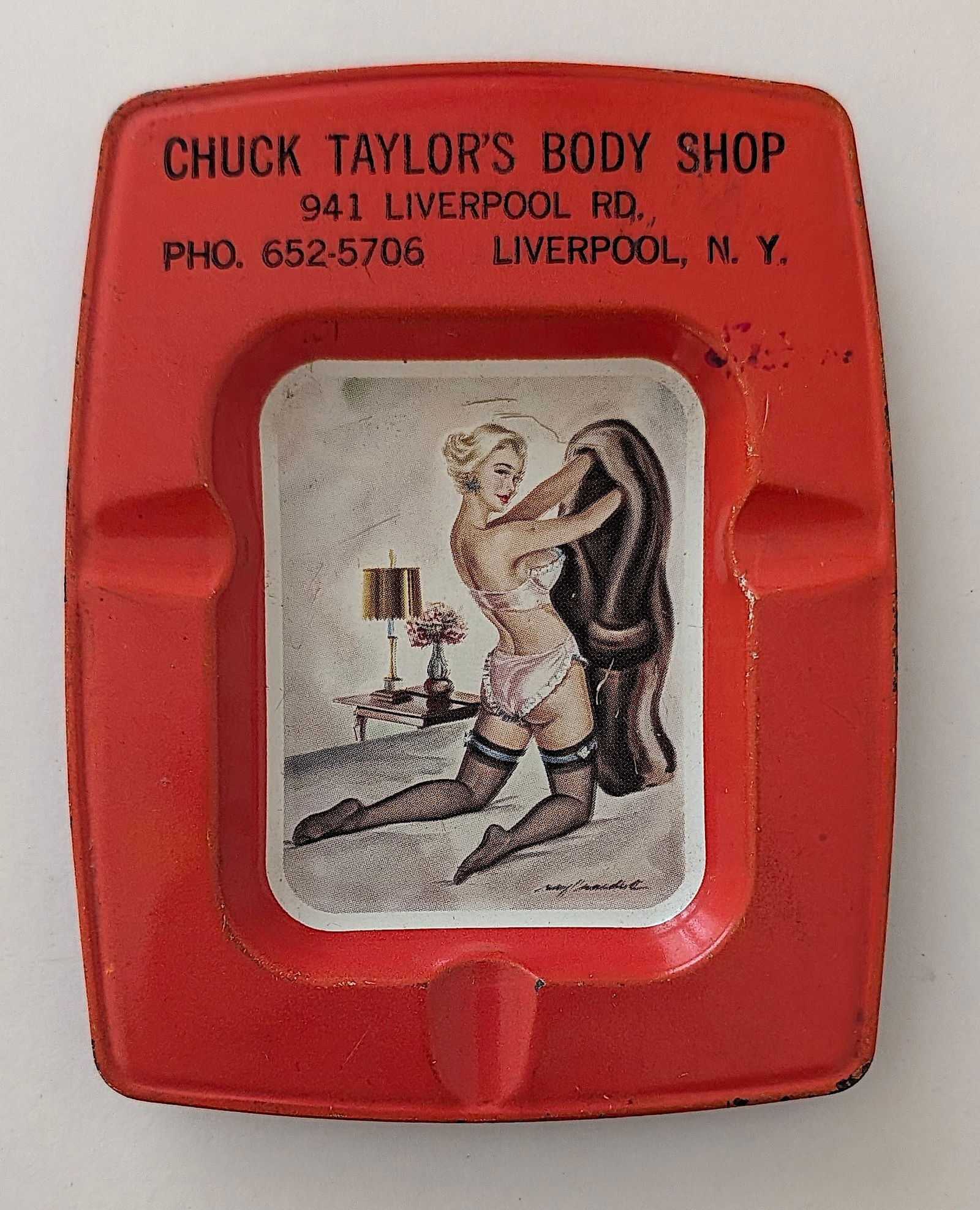 Vintage Tin Ashtray Pin-Up CHUCK TAYLOR"S BODY SHOP N. Y.: Provenance from the estate of a deceased collector in South Florida. The dimensions are Approx. 15" x 11". We have included quality images to show it's actual condition. This lot is located in Boca Ra