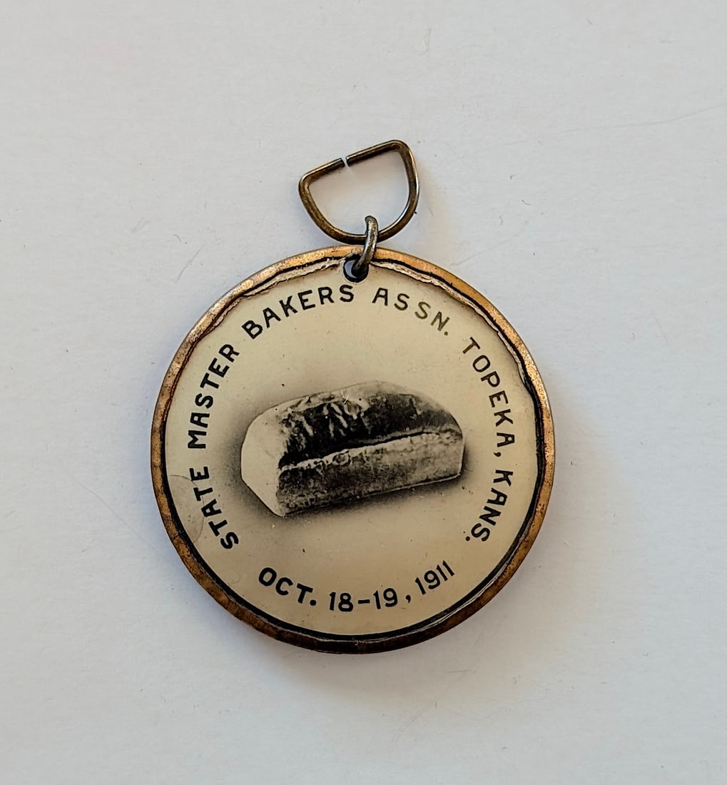 1911 Master Bakers Association Topeka KS celluloid token necklace: 1911 Master Bakers Association Topeka KS celluloid token necklace. The provenance of this item is from the inventories of Artelisted. We have included quality images to show it's actual condition. THI