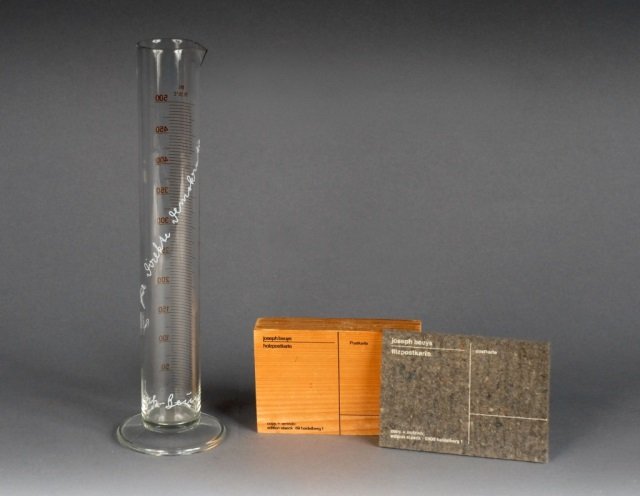 Joseph Beuys (German, 1921-1986): Comprising a woodblock postcard, signed on back in pencil, 4 x 6 inches; and a glass beaker, signed.