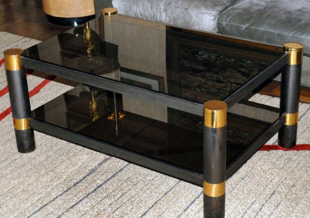 Karl Springer Brass and Glass Coffee Table: Smoked glass rectangular top on four cylindrical supports joined by a conforming lower smoked glass shelf. Height 18 inches, width 39 inches, depth 27 inches.