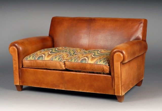 Brown Leather Upholstered Two Cushion Sofa: Rectangular back, outscrolled arms, two upholstered seat cushions. Height 29 inches, width 55 inches, depth 36 inches.