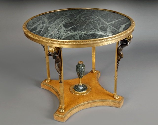 Louis XVI Style Bronze Mounted Ambroyna Gueridon: After the model by Adam Weisweiler, gilded bronze decoration. Height 32 inches, diameter 40 inches.