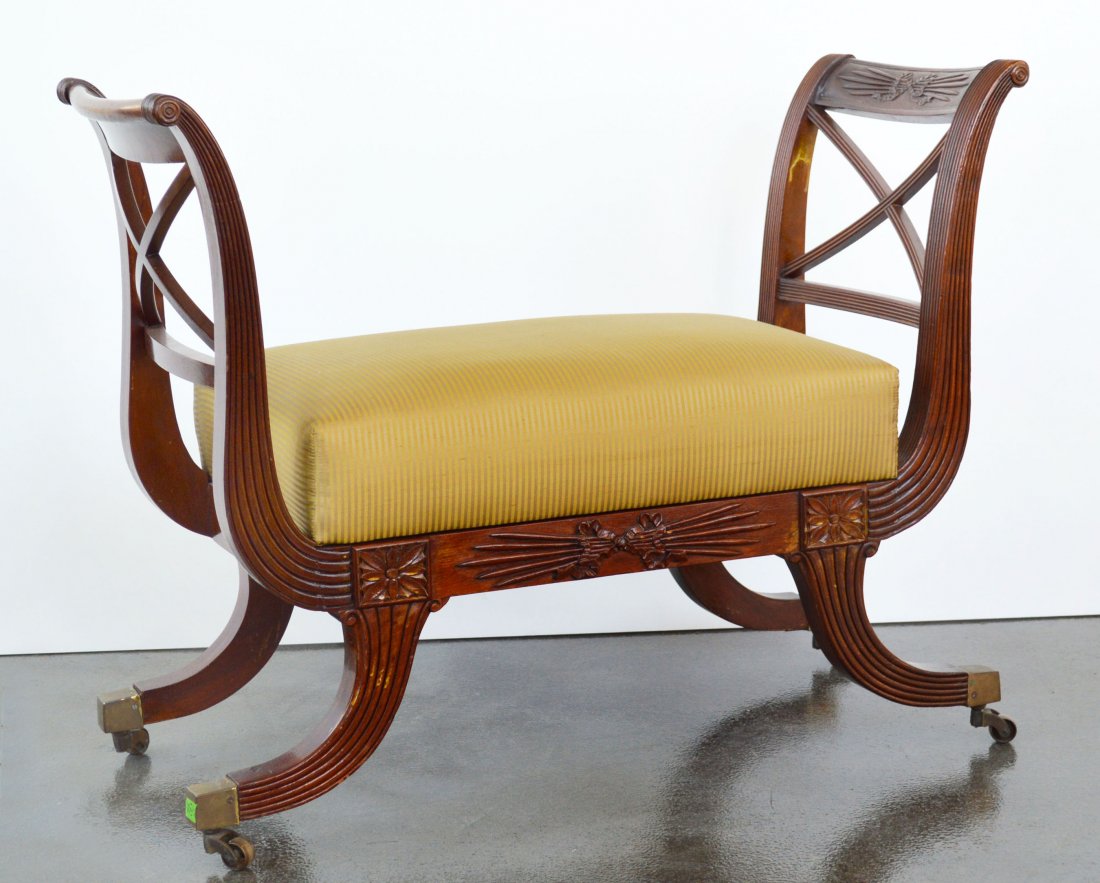 Duncan Phyfe Style Mahogany Bench: Wheat husk carved motif, rectangular seat cushion, reeded sabre legs or brass castors. Height 29 inches, width 38 inches, depth 16 inches. "Museum Reproduction Authorized by Edison Institute Dearborn,