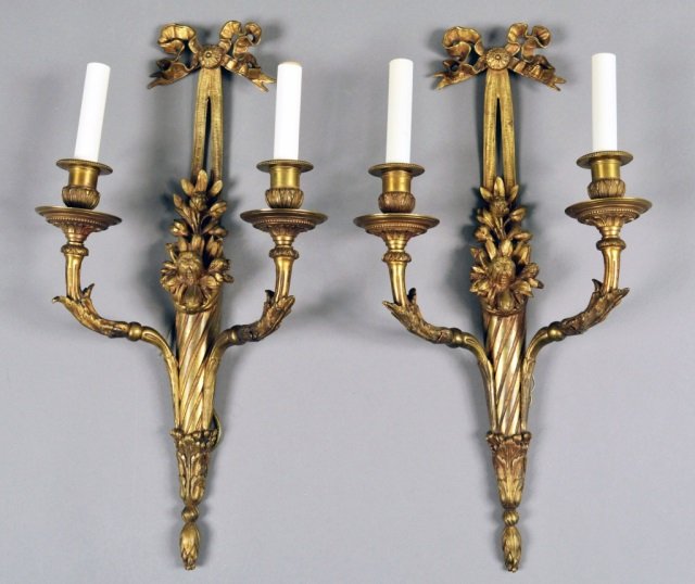 Pair of French Gilded Bronze Two Arm Sconces: Each with cornucopia and bow motif. Height 22 inches, width 11 inches.
