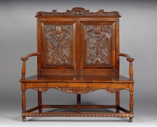 Jacobean Style Carved Walnut Settee: Height 48 inches, width 48 inches, depth 16 inches.