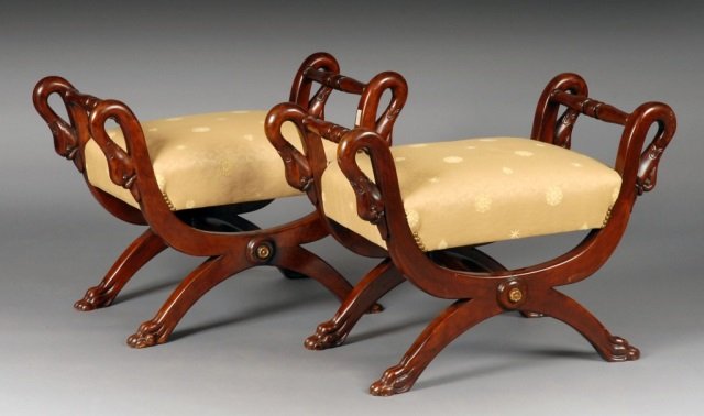 Pair of French Empire Benches: Each with rectangular over upholstered seat, figural swan head arm rests, x frame base with turned stretcher. Height 24 inches, width 37 inches, depth 17 inches.