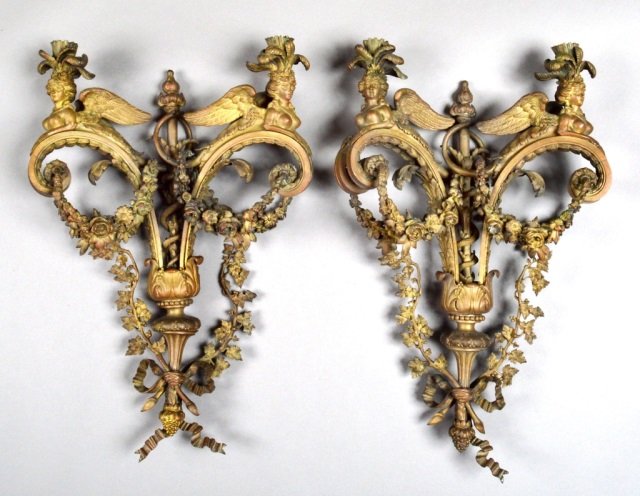 Pair of French Louis XVI Style Gilt Bronze Sconces: Figural and floral swag decoration. Height 26 inches, width 15 inches.