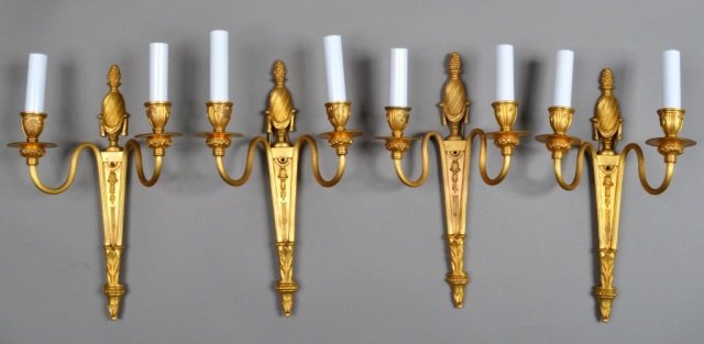 Set of Four Gilded Bronze Sconces: Each with ribbed arms and urn form back plate. Height 13 inches, width 8 inches.
