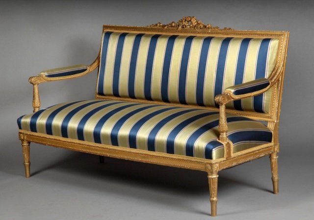 Louis XVI Style Gilt Wood Settee: Rectangular back and seat, with striped upholstery, padded arms, turned legs. Height 42 inches, width 6 feet, depth 27 inches.