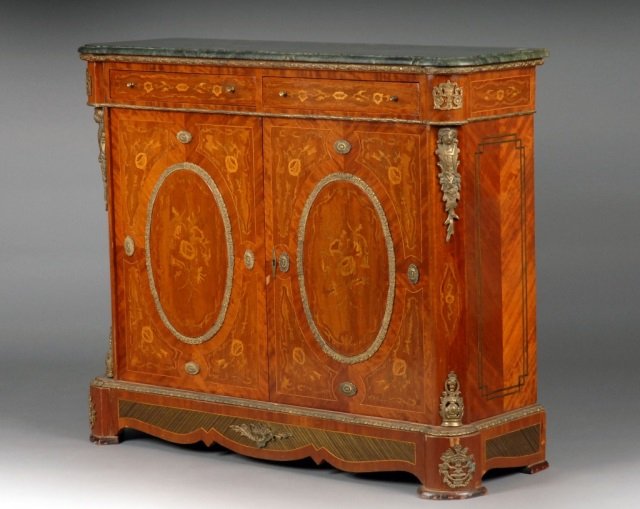 Napoleon III Style Marble Top Walnut Credenza: Rectangular green marble top above a conforming case enclosing two short drawers and a pair of cupboard doors decorated with oval medallions and foliate motifs, raised on a plinth. Height 41 1/4 inche