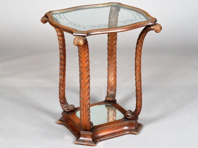 Mahogany Glass top Fireside Table: Circa 1930s. Shaped square top with inset glass surface, on four Prince of Wales feather form supports, conforming mirror top base. Height 27 inches, width 20 inches, depth 20 inches.
