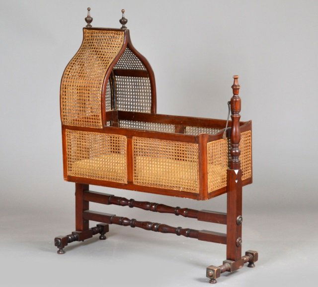 English Mahogany Regency Child's Cradle: Caned with arched top. Height 50 inches, width 39 inches, depth 16 inches.