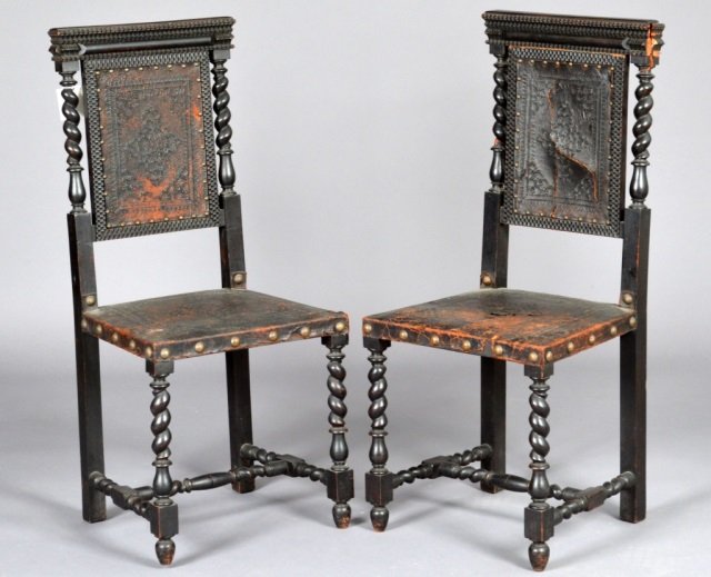 Pair of Baroque Style Ebonized Chairs: Each, carved wood with leather upholstery. Height 39 inches, width 17 inches, depth 15 inches.