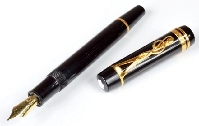 Montblanc Leonard Bernstein Fountain Pen: Limited edition. Black resin, 18K gold trim, cap rings inscribed with music and lyrics, treble clef clip. Medium 18K gold nib.