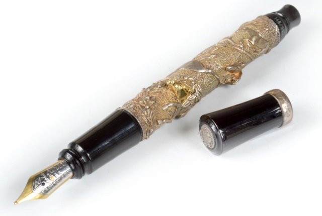 Stipula Academia Laurus Sterling Fountain Pen: High-relief engraved sterling silver, designed by Paolo Cerrini, depicting frenzied horses crossing a finish line. The winning horse has a head of gold. Medium 18K two-tone gold nib. Limited edition 1