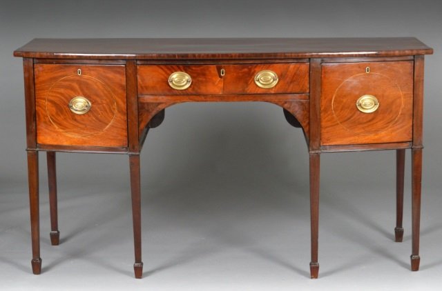 English George III Hepplewhite Mahogany Sideboard: Late 18th / early 19th century. Shaped rectangular top above a single short drawer, flanked by two large drawers, raised on square tapered legs. Height 37 inches, width 66 1/2 inches, depth 26 inches.
